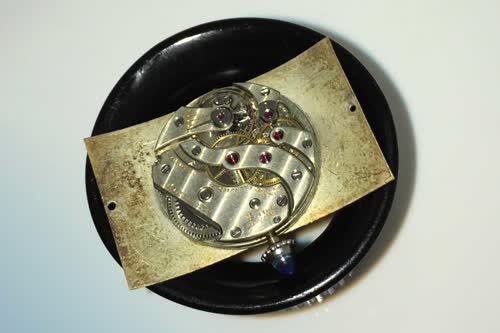 The underside of the circa 1930s Tank Cintre showing how the movement is placed in the recess of the curve of the watch's dial 