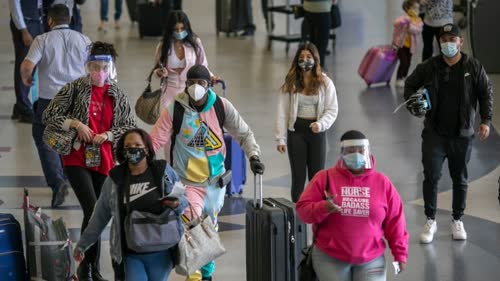 Travellers pass through Los Angeles International Airport on the eve of U.S. Thanksgiving on Wednesday. Health officials urged people to keep Thanksgiving gatherings as small as possible this year as the COVID-19 spike worsens. (David McNew/Getty Images)